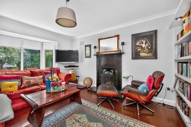 Reception room with fireplace, bay window and armchair