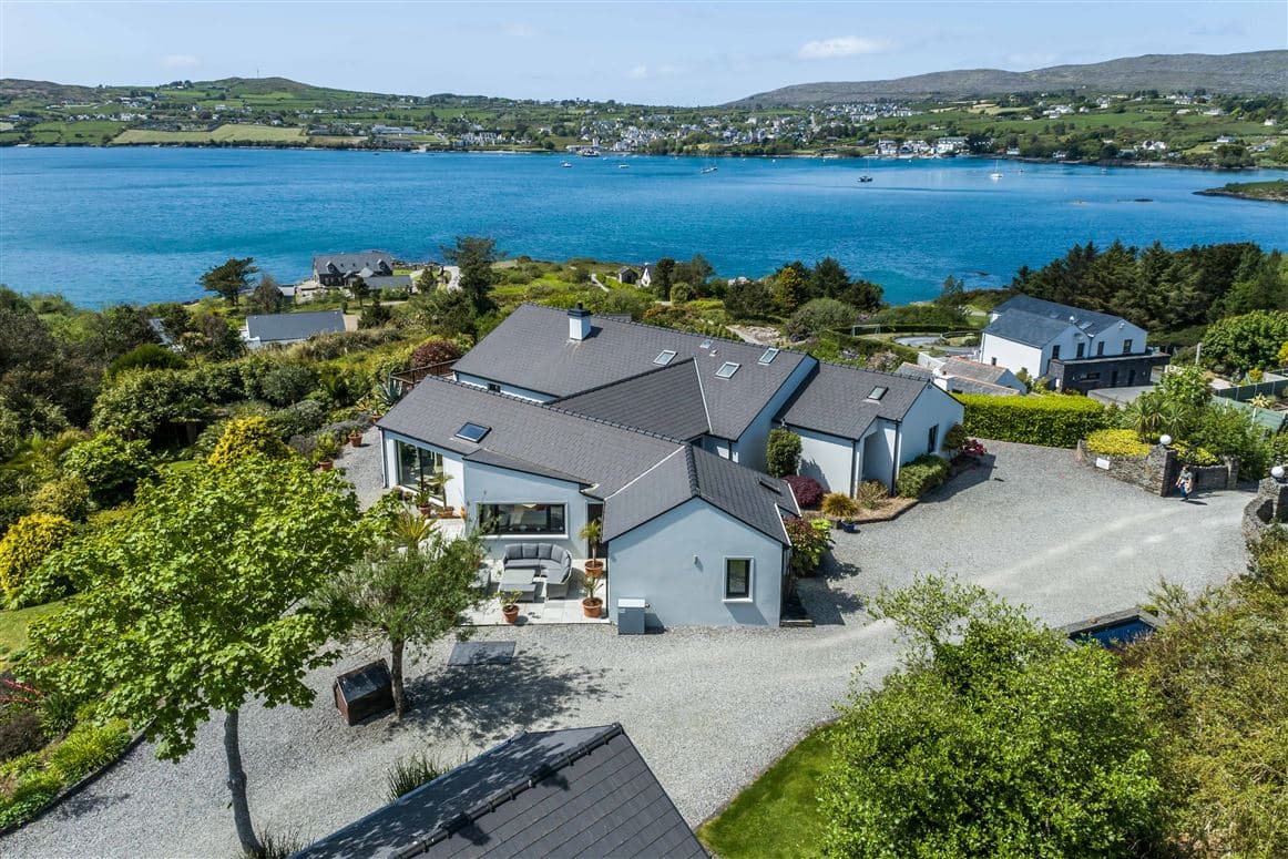 Aerial view showing the house, patio seating area and harbour views towards Schull village