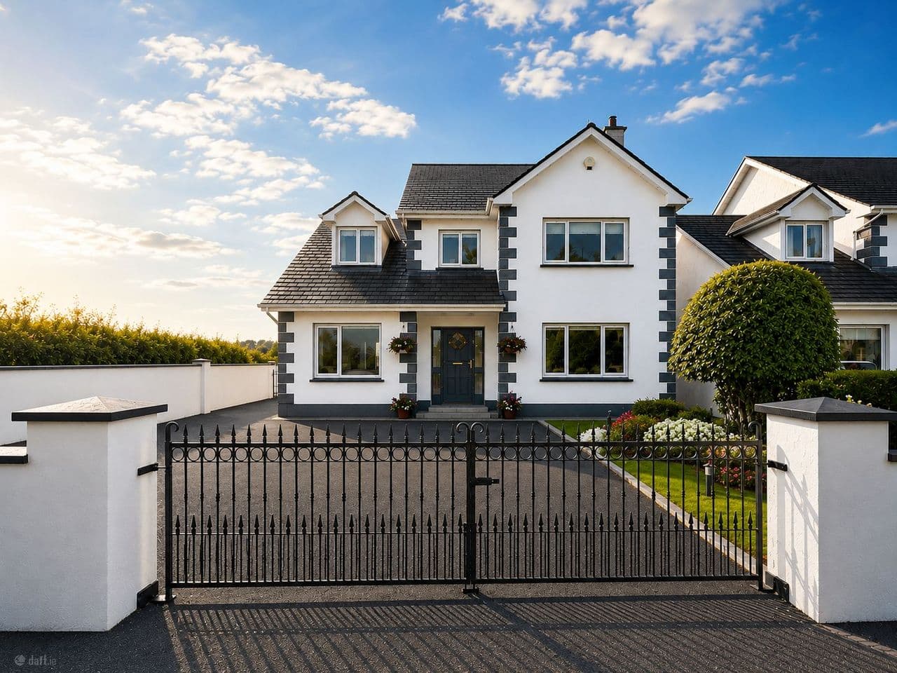 Front exterior of 29 Cois Na hAbhainn with gated driveway and front garden