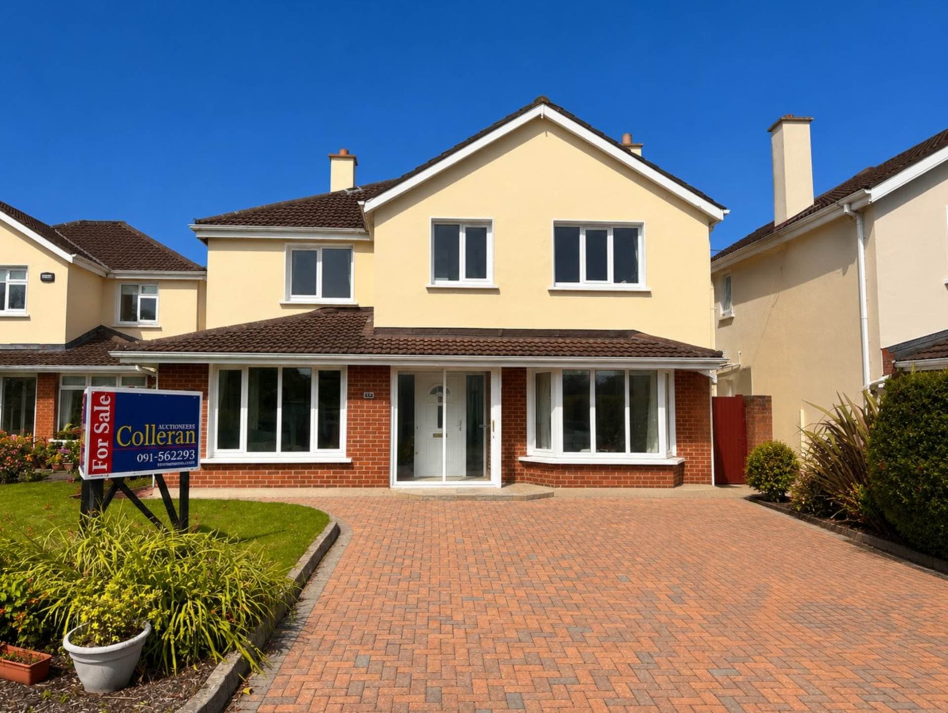 Front exterior of 74 Clybaun Heights with brick driveway and For Sale sign