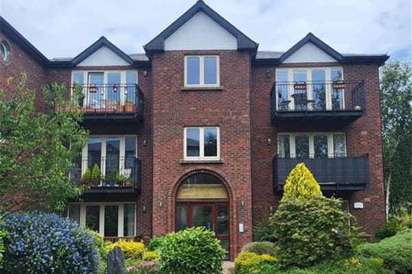 Exterior of the Eden Gate apartment building with balconies and mature planting